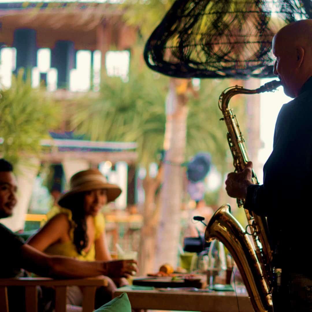 Bali music entertainment with saxophone performance for an exclusive evening in a beach lounge in Bali