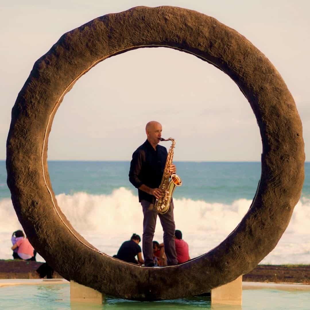 Bali music entertainment with romantic saxophone performance at sunset on a Bali beach
