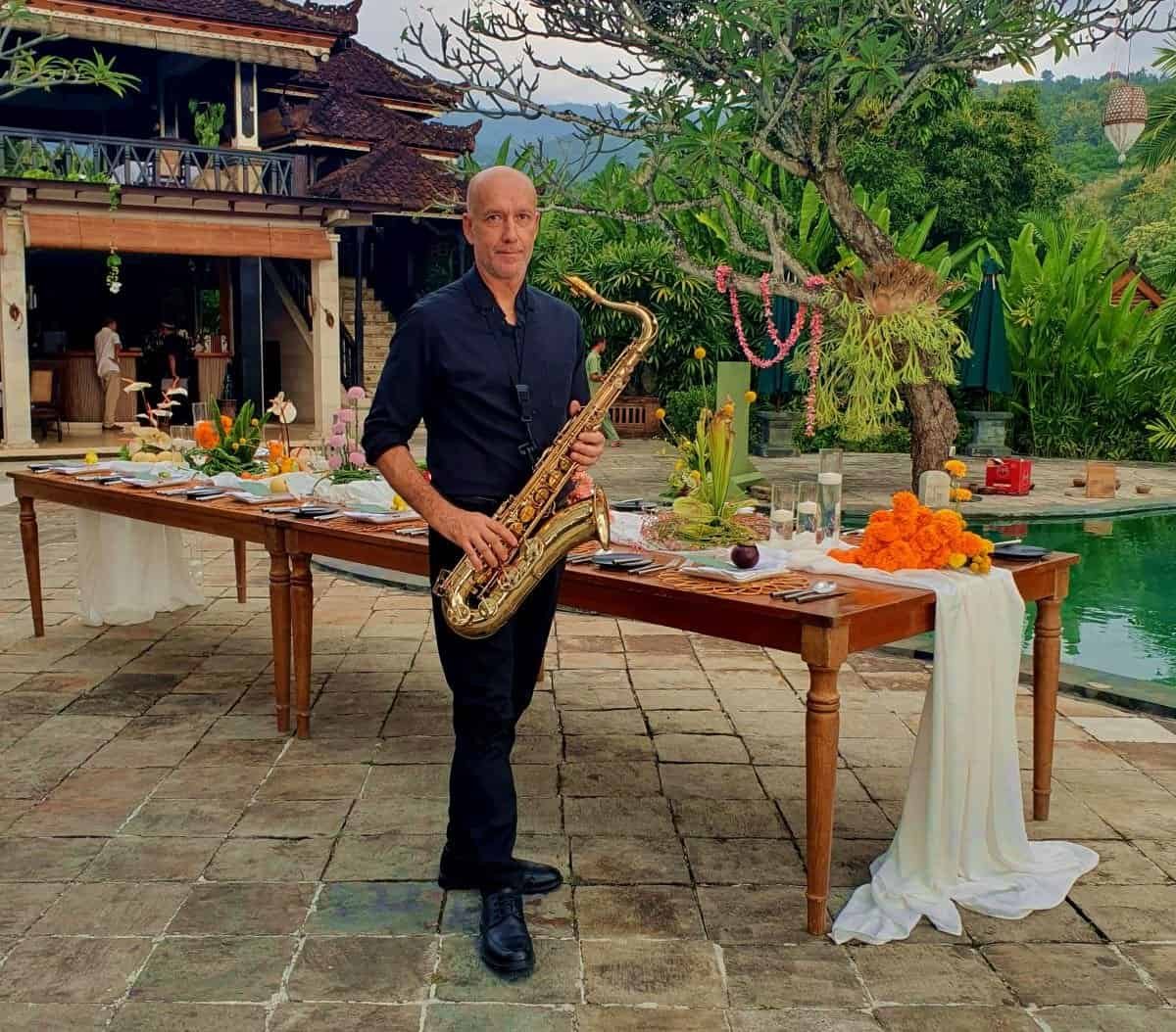 Professional saxophonist entertaining guests during a wedding cocktail at The Damai, Bali.